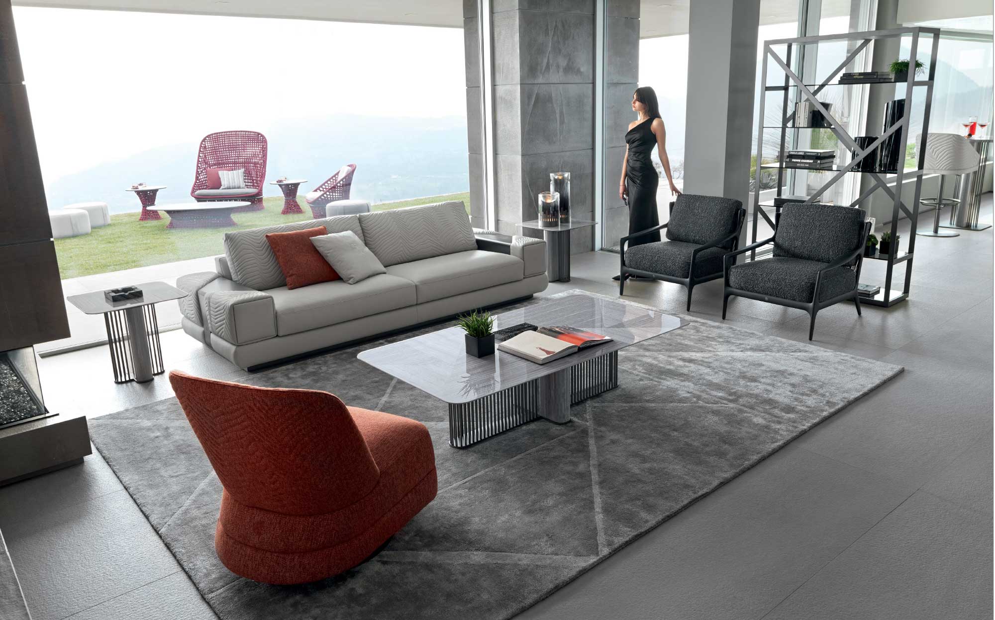 Contemporary living room with panoramic view: elegance and comfort | 101DOMUS Modern living room with grey sofa, black armchairs, orange armchair and glass coffee table with metal base