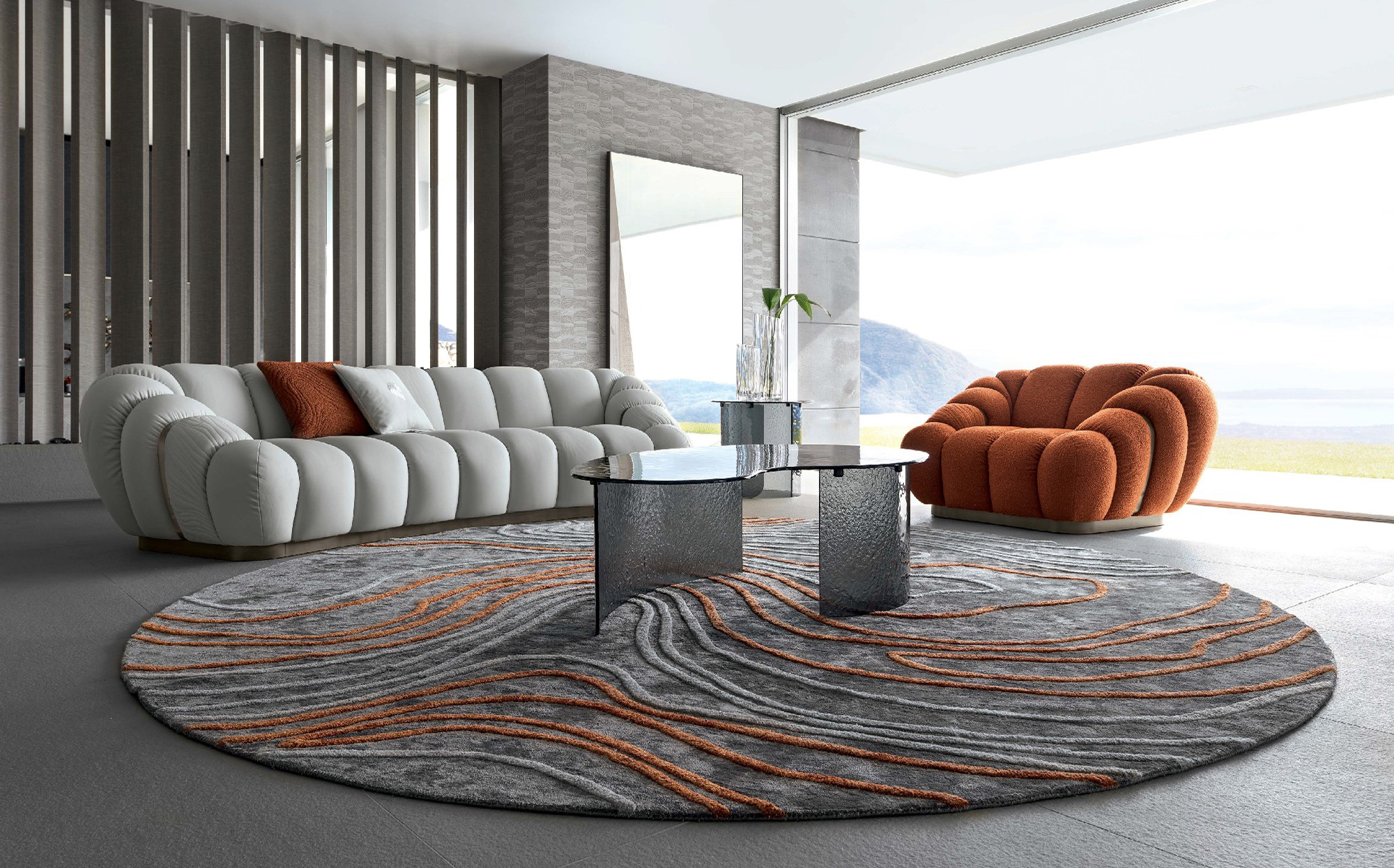 Contemporary elegance with bold color contrast in a modern living space | 101DOMUS Modern living room with white sofa, orange armchair and round patterned rug