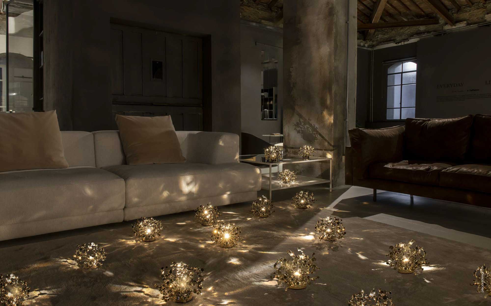 Terzani floor lamps shaped like golden spheres creating a suggestive atmosphere in the living room | 101DOMUS Terzani lighting installation with floor lamps shaped like small golden spheres in a modern living room