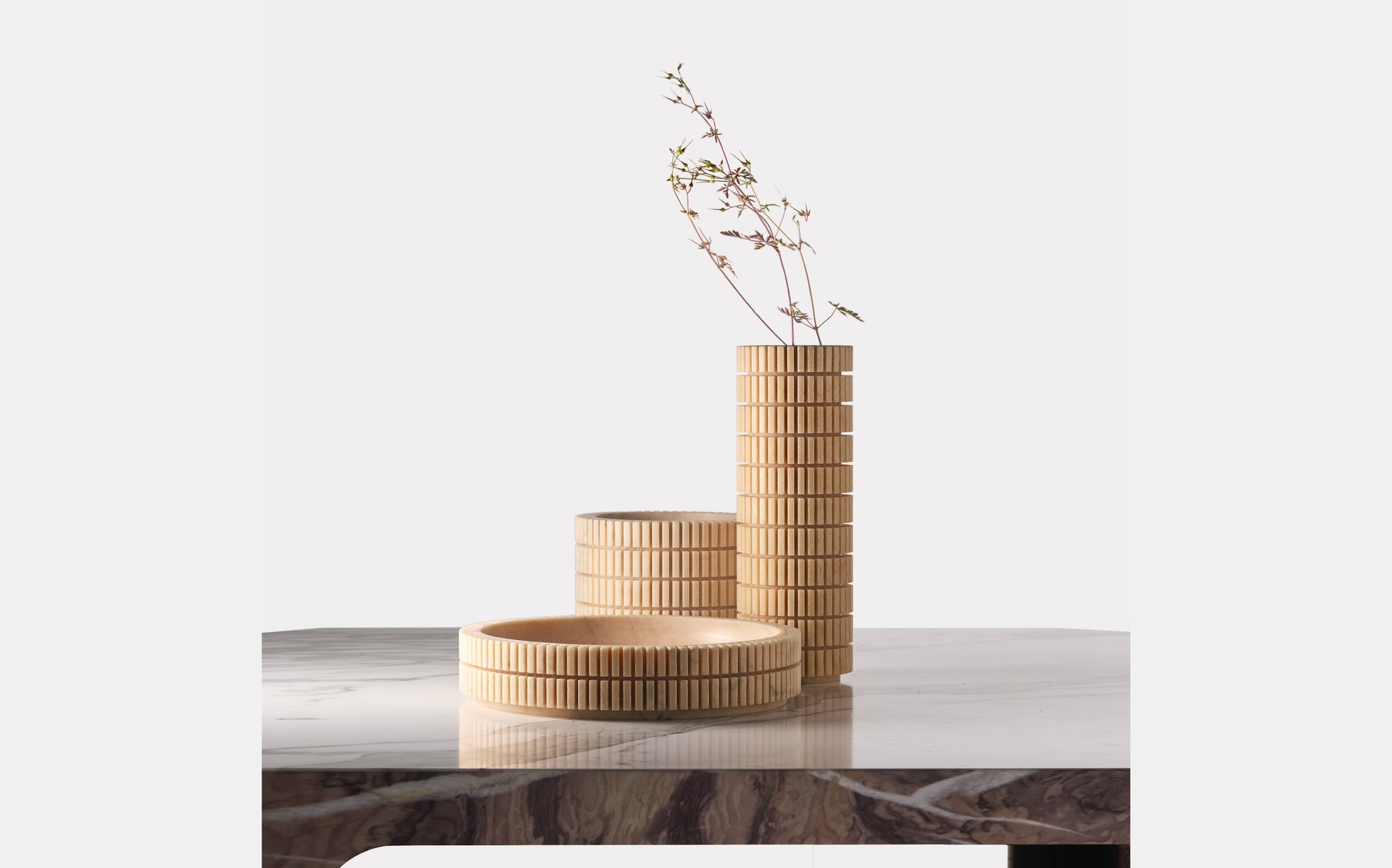 Bufalini ribbed stone vases and bowl on a marble table designed by Paolo Ulian