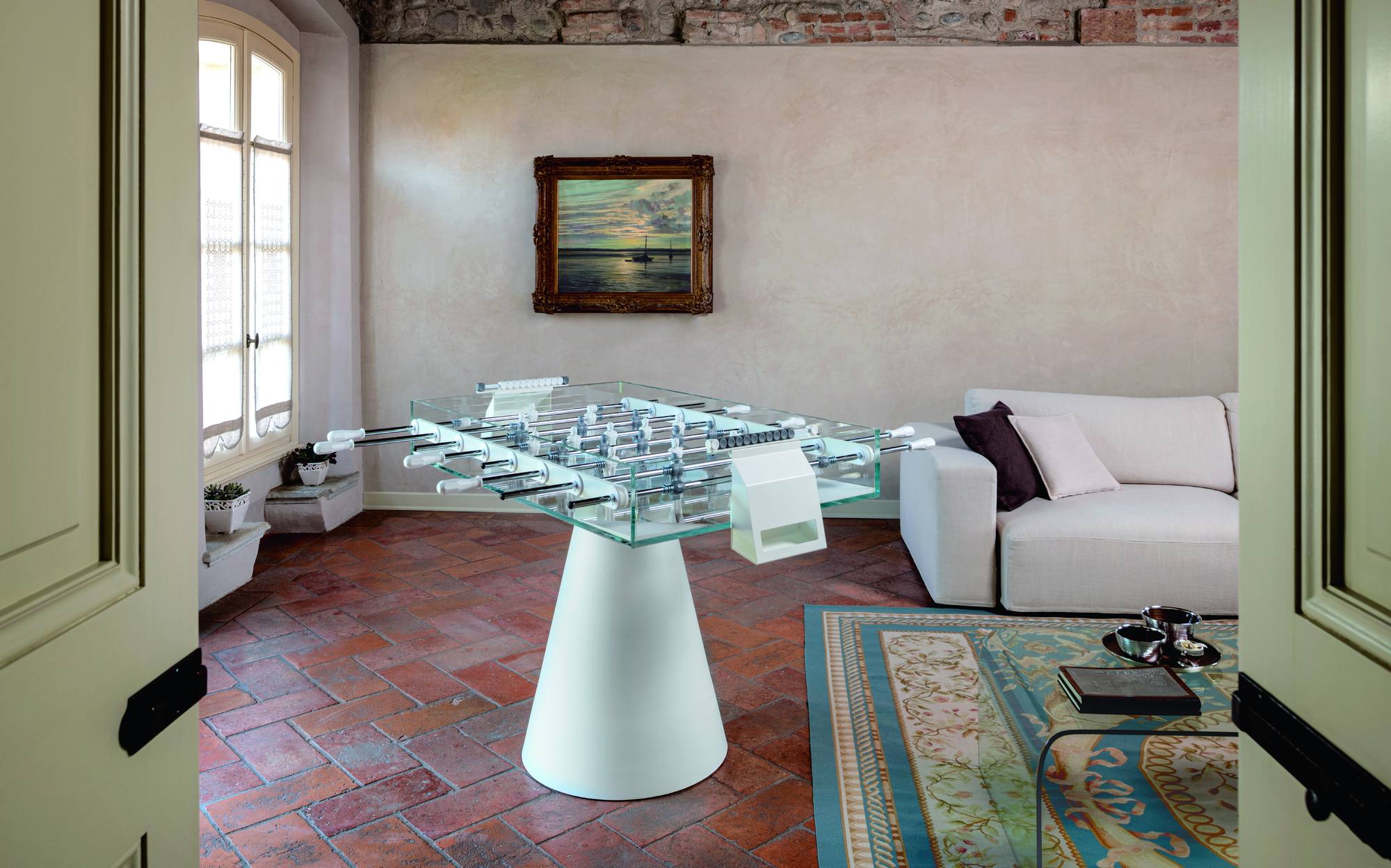 FAS Pendezza Ghost luxury glass foosball table with white cone base in an elegant Italian living room