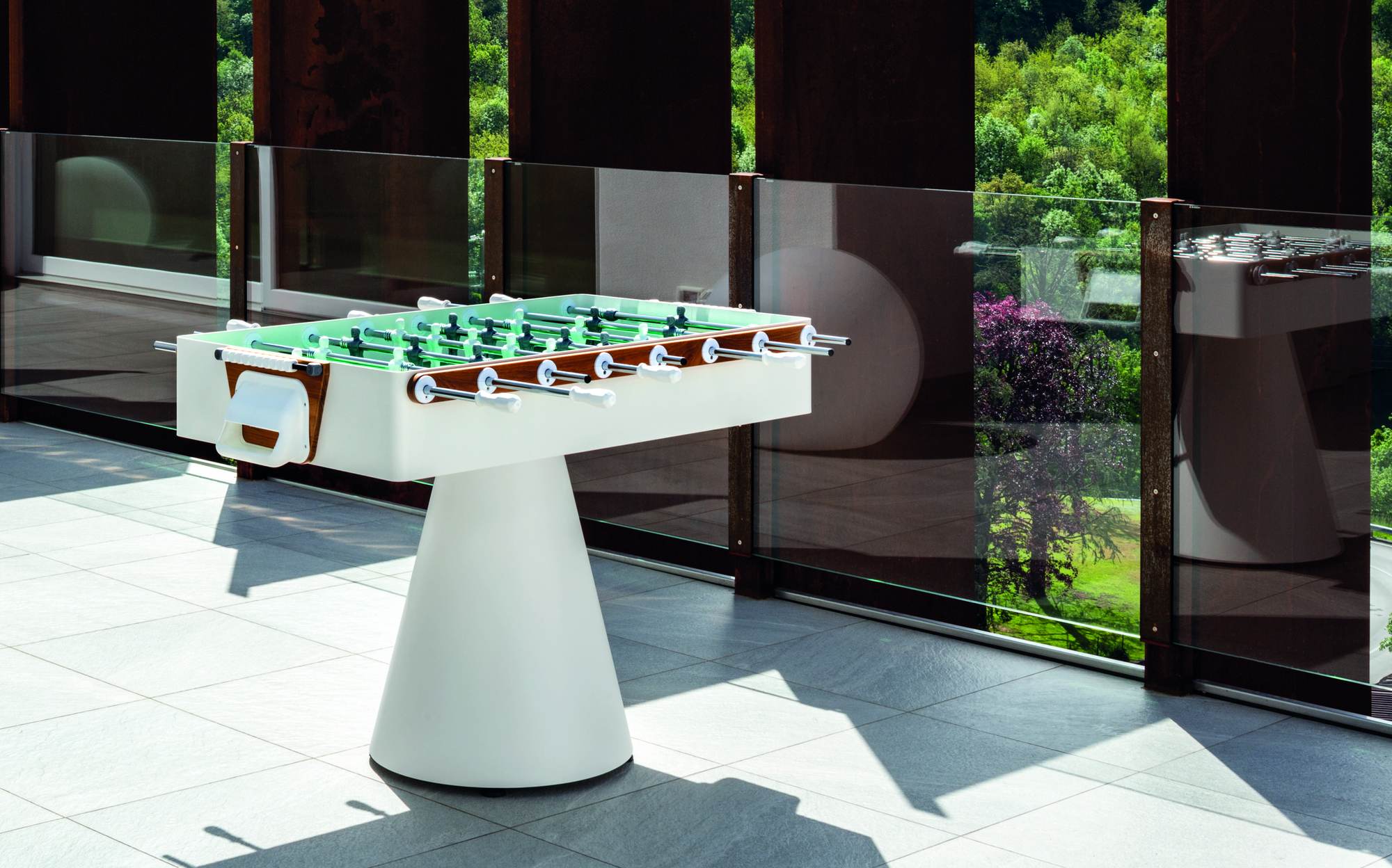 FAS Pendezza Ciclope designer outdoor foosball table with white cone base on a panoramic terrace