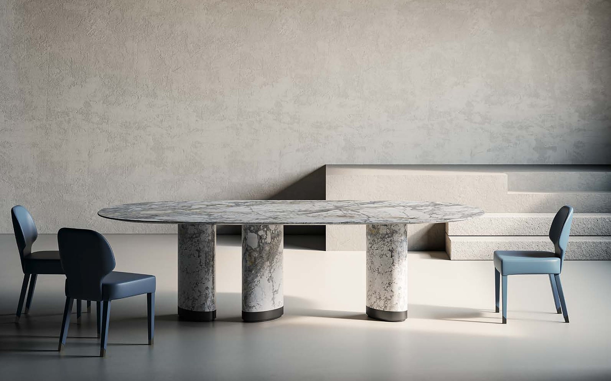Profilo9 Collection 2026 marble dining table with column legs and blue chairs Profilo9 Collection 2026 marble dining table with column legs and blue chairs – Italian luxury furniture in marble and metal