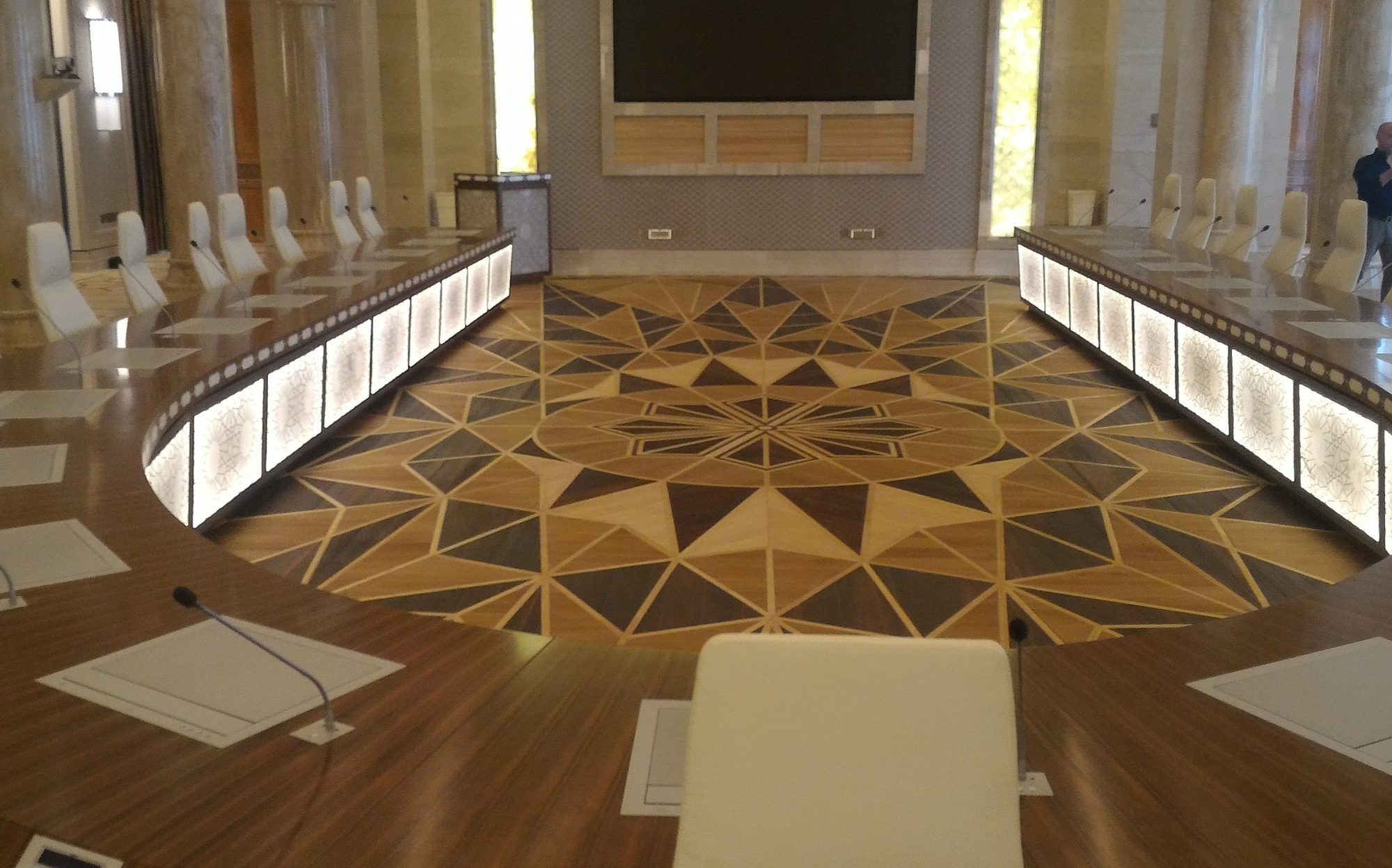 Geometric wood marquetry floor framed by the curved council table, Presidential Palace Abu Dhabi | 101domus