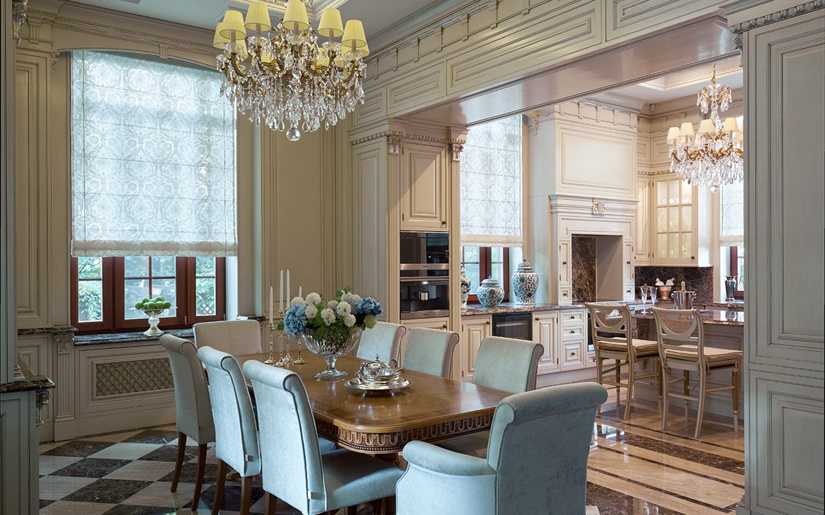 Dining room with long table and upholstered chairs open to the kitchen, Francesco Molon villa in Italy | 101domus