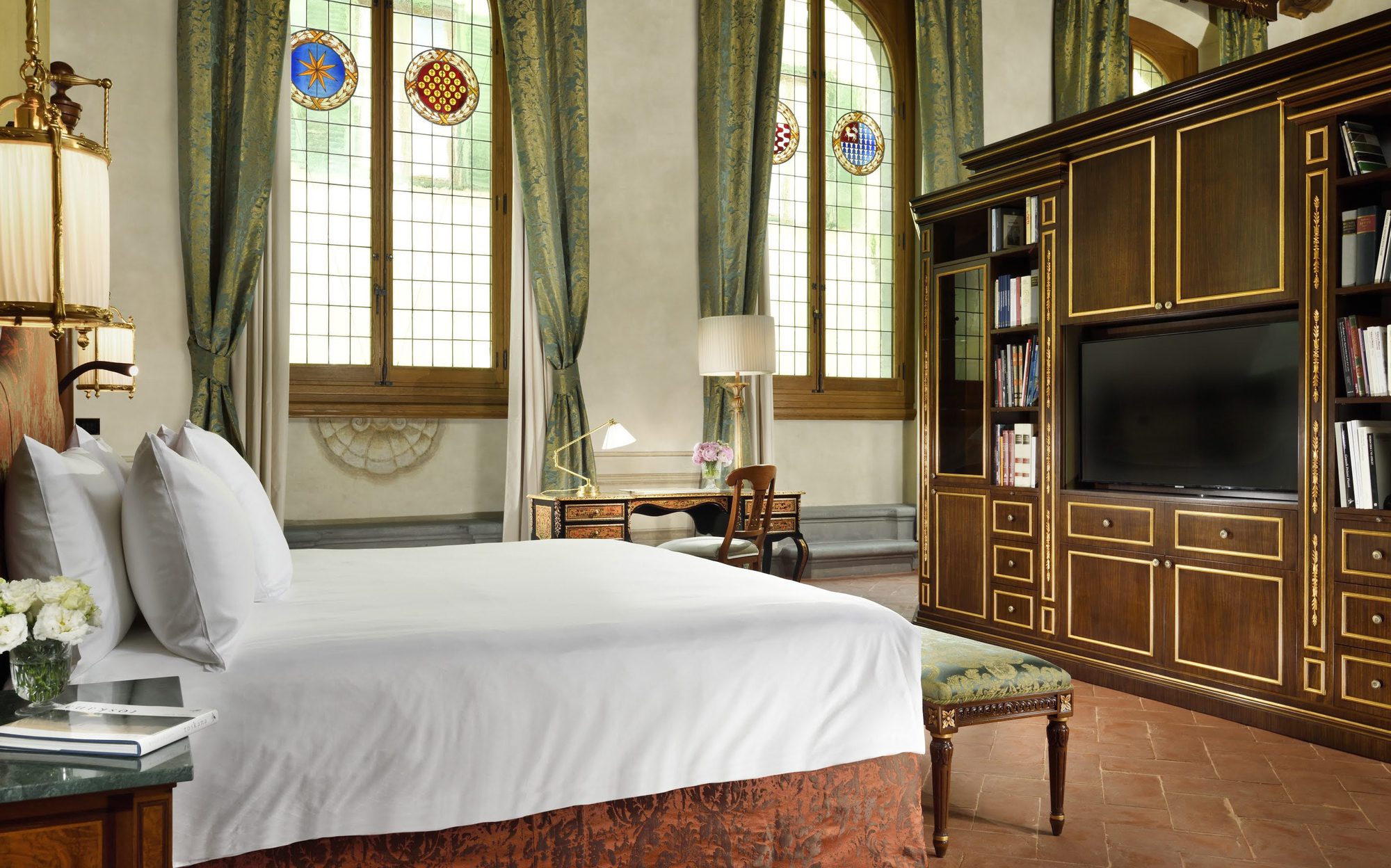 Bedroom with stained-glass windows and bookcase TV wall, Francesco Molon suite in Florence | 101domus