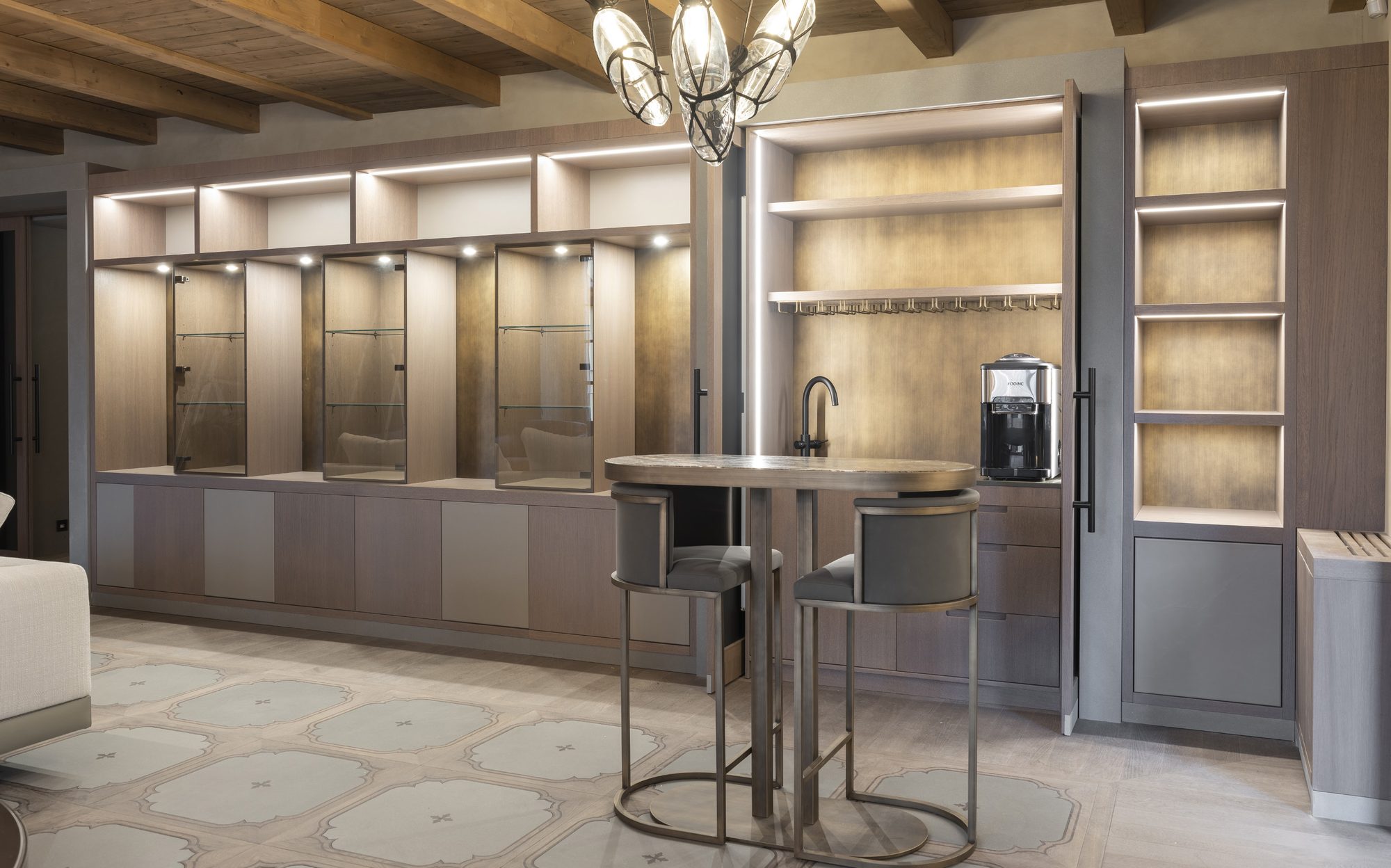 Kitchenette with backlit cabinetry and bar table, apartment at Palazzo Portinari Salviati Florence | 101domus